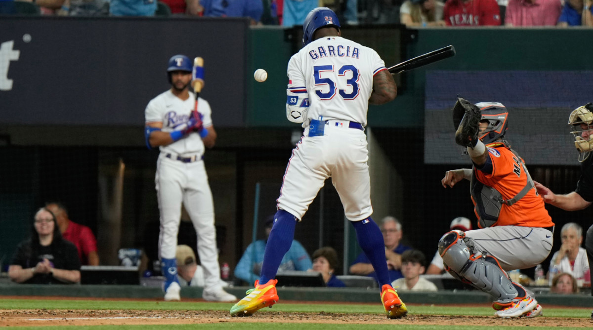 Texas Rangers' Adolis Garcia (53) is hit by a pitch thrown by Houston Astros relief pitcher Bryan Abreu during the eighth inning in Game 5 of the baseball American League Championship Series Friday, Oct. 20, 2023, in Arlington, Texas. (AP Photo/Godofredo A. Vásquez)   